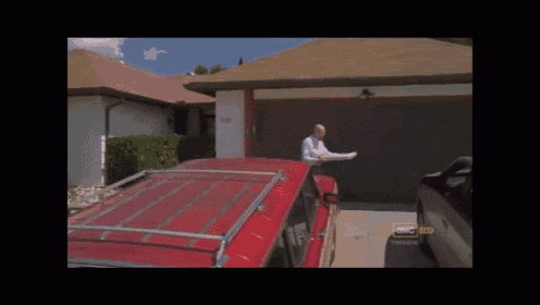 a red suv is parked in front of a house with a sign that says ' a & mc ' on it
