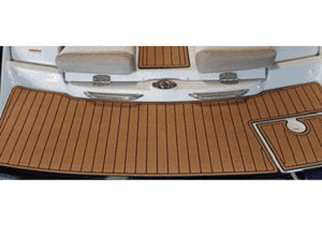 a boat with a wooden deck and cushions on the seats