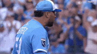 a baseball player wearing a blue jersey with the number 3 on the back