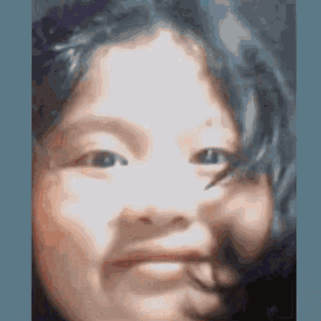 a close up of a child 's face with a blurred background