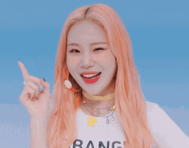 a girl with pink hair wearing a white shirt that says bang