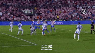 soccer players on a field with a sign that says messi world on it