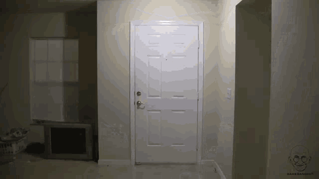 a white door in a hallway with a picture of a skull on the wall