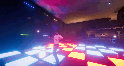 a man in a white shirt is dancing on a dance floor in a club