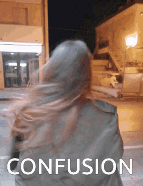 a woman walking down a street with the word confusion written below her