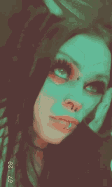a close up of a woman 's face with the date 07 20