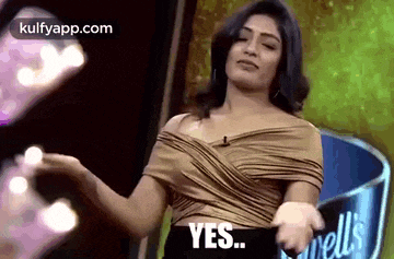 a woman is dancing in front of a microphone and says yes .