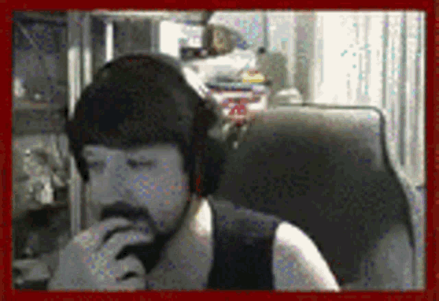 a person wearing headphones is sitting in a chair with their eyes closed