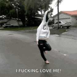 a woman in a hoodie is jumping in the air with the words `` i fucking love me '' .