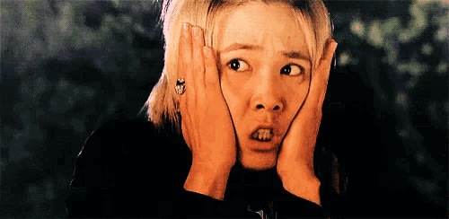 a woman with a ring on her finger is making a surprised face