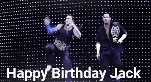 two wrestlers are dancing in front of a screen that says happy birthday jack