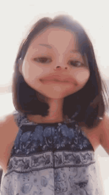 a young girl is making a funny face with her mouth open .