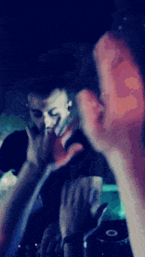 a blurry photo of a man giving a middle finger