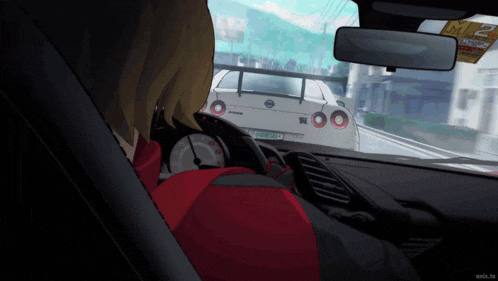a person in a red jacket is driving a car with a license plate that says ' nmr '