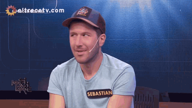 a man wearing a blue shirt with the name sebastian on it