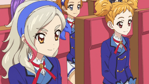 a group of anime girls are sitting in a theatre
