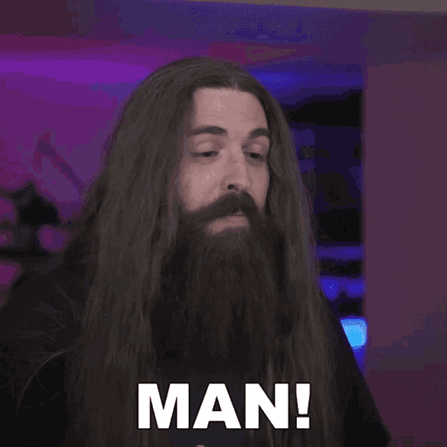 a man with long hair and a beard says the word man