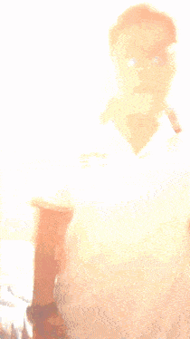 a blurry picture of a man wearing sunglasses and a white shirt that says ' united states ' on it