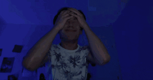 a man in a palm tree t-shirt is making a funny face