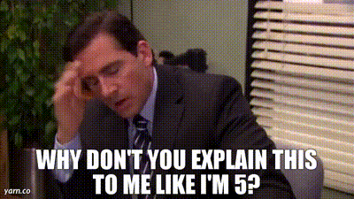 a man in a suit and tie is sitting at a desk with his hand on his forehead .