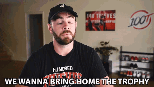 a man wearing a black shirt that says hundred thieves