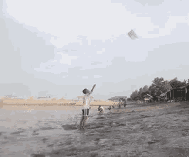 a man is flying a kite on a beach