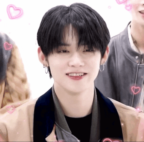 a close up of a person 's face with hearts around him
