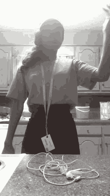 a black and white photo of a woman wearing a lanyard with a name tag that says ' amanda '