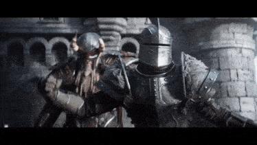 a man in armor is standing next to another man in armor
