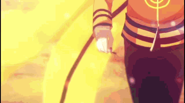 a person is holding a sword in their hand in front of a fire .