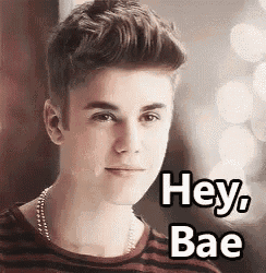 a young man is wearing a striped shirt and a necklace and says `` hey bae '' .