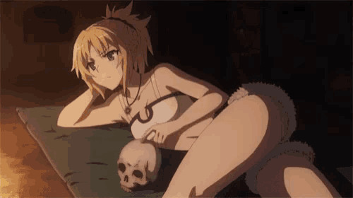 a girl is laying on a bed holding a skull .