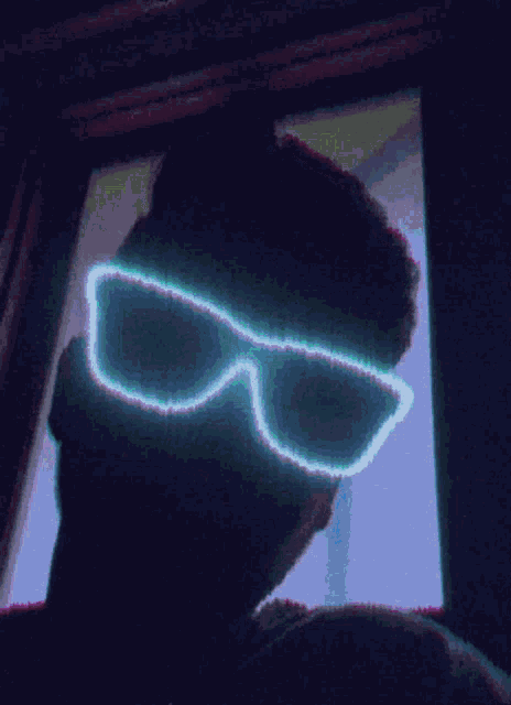 a man wearing a pair of neon sunglasses