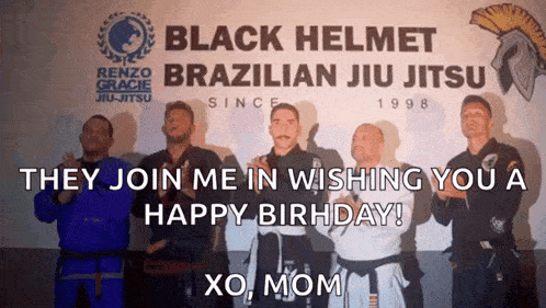 a group of men standing in front of a black helmet brazilian jiu jitsu sign