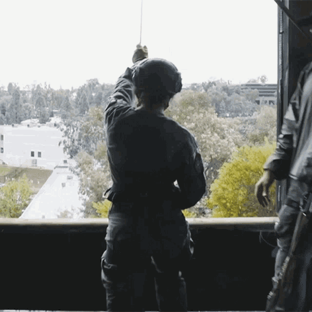 a man in a helmet looks out of a window