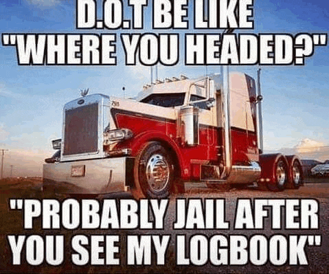 a red and white semi truck is parked on the side of the road in a field .