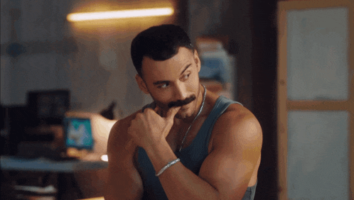 a man with a mustache is wearing a bracelet on his wrist