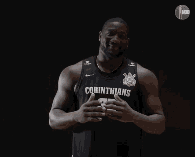 a man wearing a black corinthians jersey with the number 32 on it