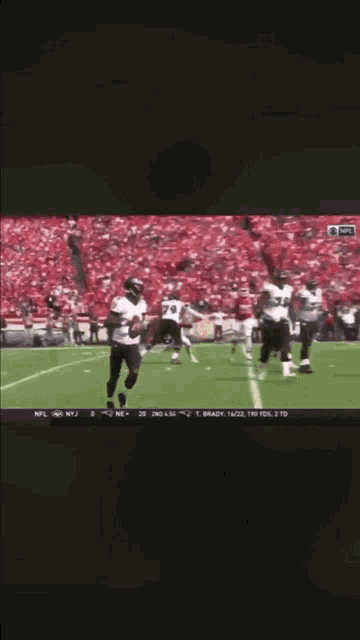 a football game is being played on a tv screen with the nfl logo on it