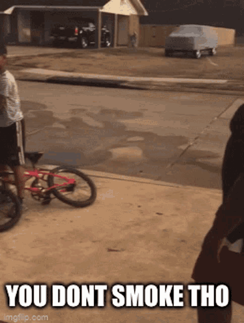 a man riding a bike with the words you dont smoke tho
