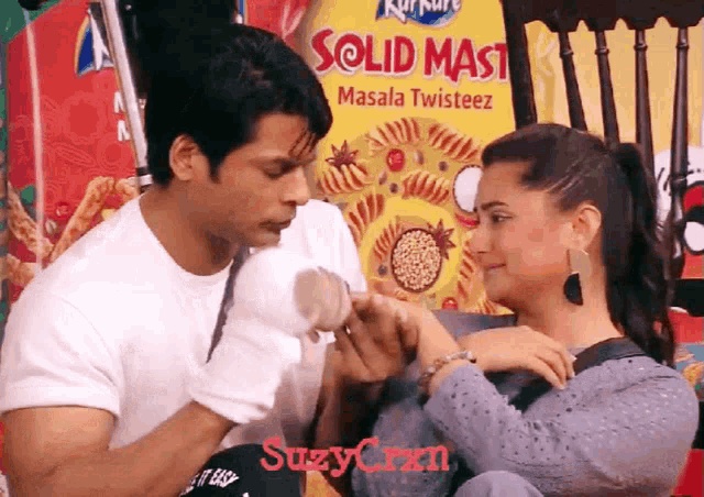 a man and woman are holding hands in front of a solid mast masala twisteez advertisement
