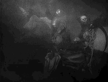 a black and white photo of a skeleton in a foggy room