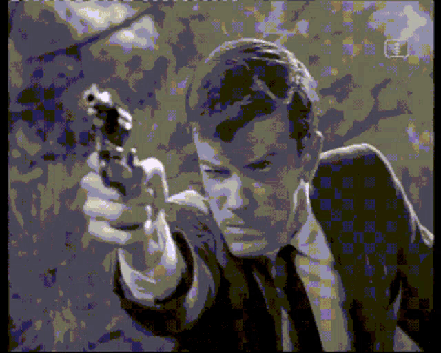 a man in a suit and tie is pointing a gun at someone