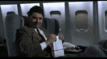 a man in a suit is sitting on an airplane