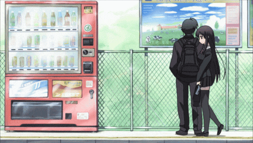 a boy and a girl standing in front of a vending machine that says ' new ' on it
