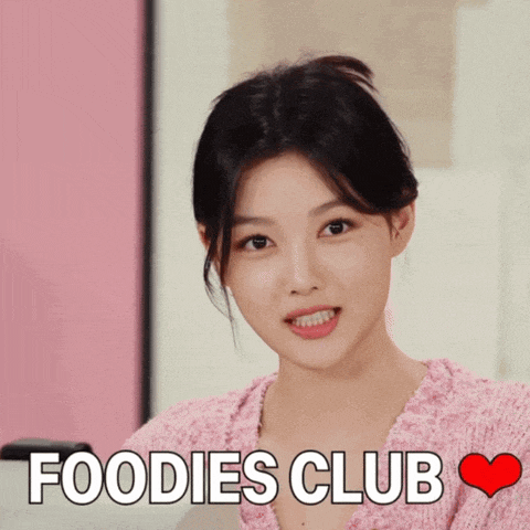 a woman in a pink sweater with the words " foodies club " below her