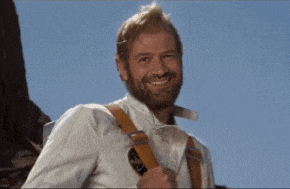 a man with a beard wearing suspenders and a white shirt