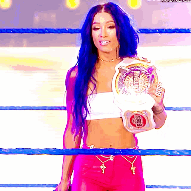 a woman with blue hair is holding a belt that says boss on it