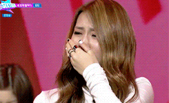 a woman is covering her mouth with her hand and the word star is on the screen