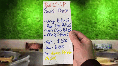 a person holding a note that says roll it up sushi palace